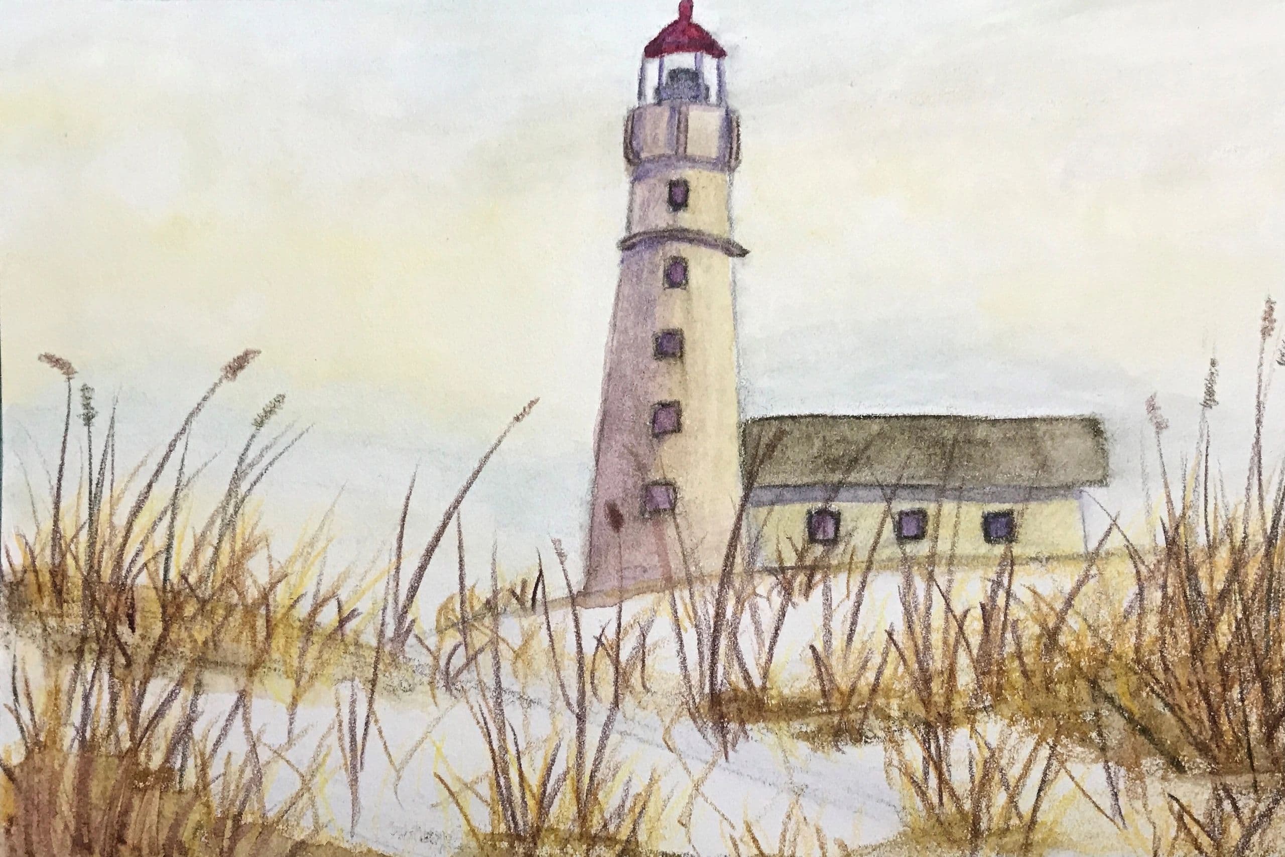 Lighthouse by the sea with sand dunes and sea oats